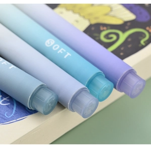 Close-up of soft gradient blue and purple highlighters with frosted texture barrels
