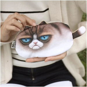 Detail of plush cat coin purse featuring blue eyes cat print and branded woven label