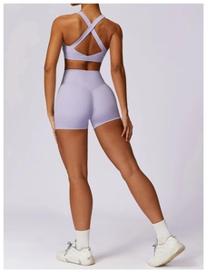 Rear view of lavender yoga set showing cross back sports bra and high waist shorts