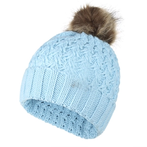 Detail of blue cable knit beanie featuring thick texture and dark brown faux fur pom-pom