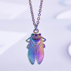 Detail view of the colorful iridescent cicada pendant with textured metallic wings