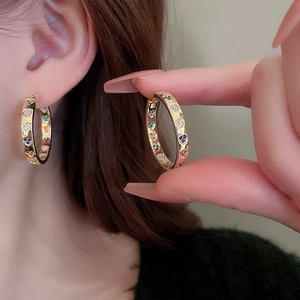 Golden hoop earrings with colorful heart shaped patterns and metal finish for women