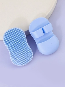 Macro detail of soft blue silicone facial brushes with ergonomic finger loop handles