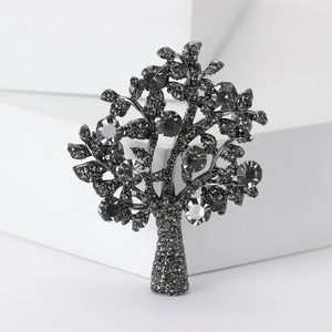 Detail of elegant tree of life brooch with sparkling rhinestones on alloy frame