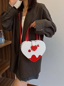Chic heart-shaped crossbody bag with crocodile pattern and red arrow buckle detail
