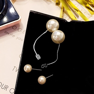 Elegant pearl tassel earrings with silver chains and white pearls on black background