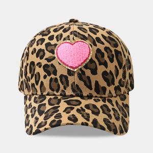 Detail of pink towel-embroidered heart patch on leopard print cotton baseball cap