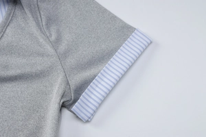 Detail of grey short sleeve cuff with blue and white striped fabric patchwork design