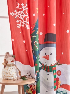 Close-up of festive red Christmas snowman curtains hanging in a warm home setting