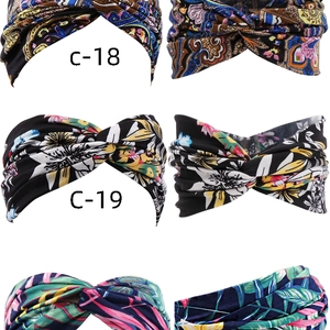 Detail view of four bohemian style elastic headbands with twisted cross design patterns
