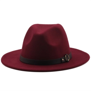 Close-up of burgundy wool felt fedora with black leather band and gold metal buckle detail
