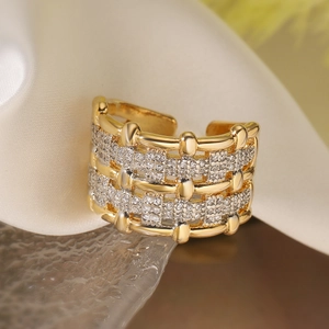 Macro detail of gold plated wide band ring with multi-row pavé white zircon stones