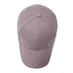 Pink and grey houndstooth plaid wool baseball cap with small gold logo on white background