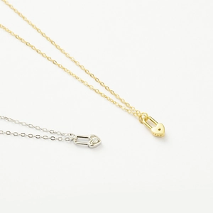 Close-up of gold and silver S925 sterling silver heart lock necklaces with crystal