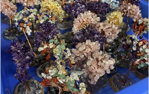 Macro shot of assorted crystal gemstone trees with copper wire and agate stone bases