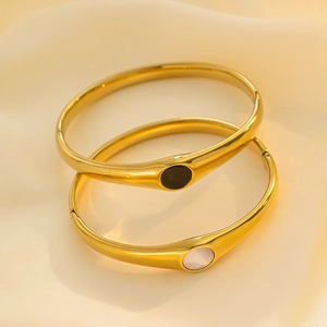 Vintage gold stainless steel open bangles with black and white shell inlays on silk