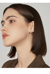 Close-up of elegant S925 silver bow earrings worn by a model for a stylish look