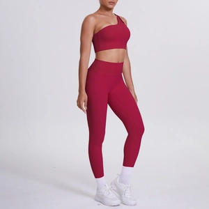 Detail of dark red one-shoulder sports bra and high-waist yoga leggings set