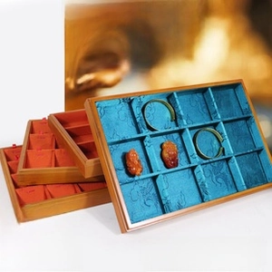 Bamboo jewelry display tray featuring multi-grid compartments and silk lining