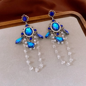Detailed shot of vintage blue gemstone earrings with elegant long beaded tassels