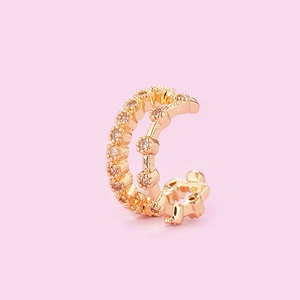 Detailed macro view of a golden double-layered ear cuff set with tiny sparkling crystals