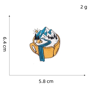 Macro view of cup-shaped mountain embroidery patch showing 6.4x5.8 cm dimensions