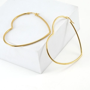 Minimalist gold-plated stainless steel heart-shaped hoop earrings for women on white stones