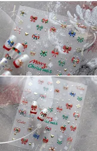 Close-up of 5D embossed Christmas nail stickers featuring snowflakes and golden bows