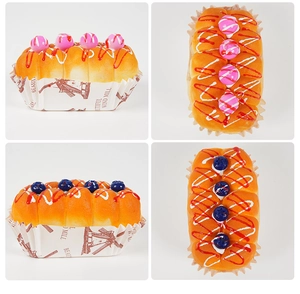 Detailed macro view of artificial PU cupcake with realistic fruit jam and windmill paper base