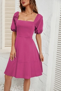 Detail view of square neckline and puff sleeves on the magenta casual summer dress