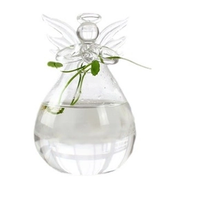 Handmade clear glass angel vase with green hydrophyte on a clean white background