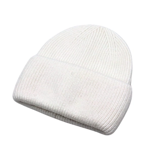 Detail of white knit beanie showing vertical ribbed texture and folded cuff design