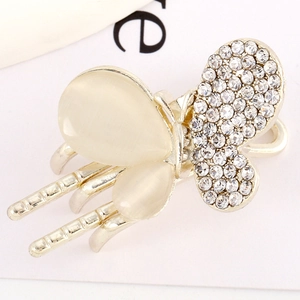 Macro view of butterfly hair claw clip with rhinestones and cream opal stones