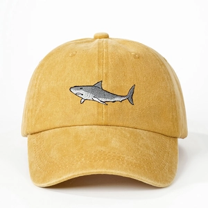 Adjustable washed canvas baseball cap in mustard yellow with a shark embroidery detail