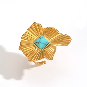 Golden ring featuring a square turquoise stone and irregular sunburst textured design