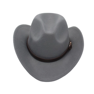 Detail of grey felt cowboy hat with leather band and gold buckle on a white background