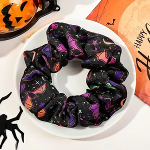 Detail of Halloween scrunchie with colorful bats and stars on a white display plate