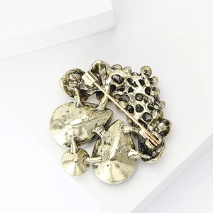 Detailed back view of vintage gold flower brooch showing the secure pin fastener