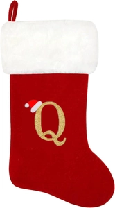 Macro detail of red Christmas stocking featuring a glittery gold letter Q and plush white cuff