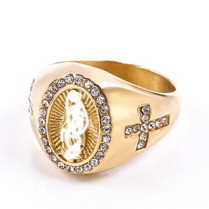 Macro detail of gold Mary ring with cross side design and sparkling crystal inlay