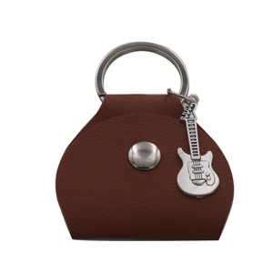 Close-up of brown leather guitar pick holder with silver snap and guitar pendant
