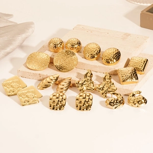 Set of gold 18K plated geometric earrings with textured hammered finish on velvet surface