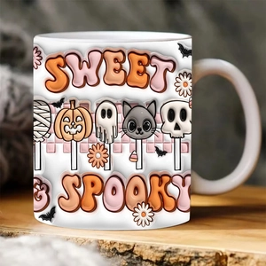 Close-up of Halloween ceramic mug with colorful Sweet Spooky text and cartoon patterns