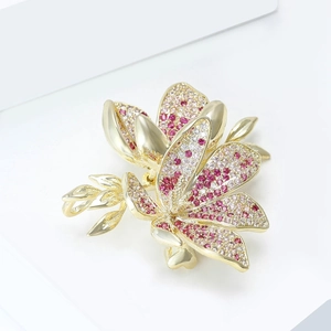 Macro shot of cubic zirconia flower brooch with pink and purple gradient petals