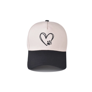 Detail of two-tone cotton baseball cap showing heart and paw print on beige crown