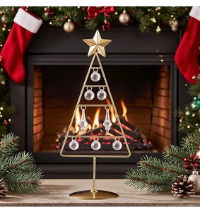 Detailed view of a golden wrought iron LED Christmas tree with crystal glass ornaments