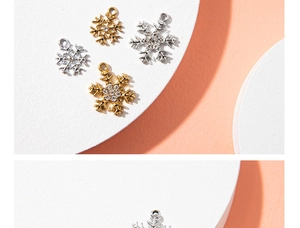 Macro detail of snowflake pendants with sparkling rhinestones in gold and silver plating