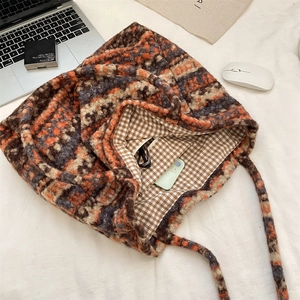 Detailed view of plush geometric tote interior showing spacious storage and checkered lining