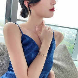 Elegant gold zircon flower bracelet for women on wrist with minimalist floral pattern