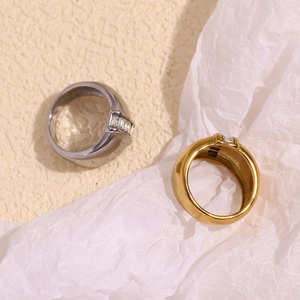 Macro shot of wide gold and silver plated rings featuring rectangular zircon stones